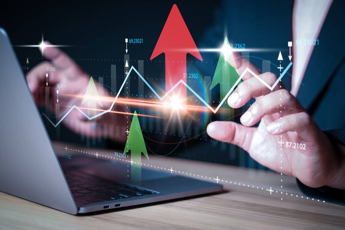 Businessman touching chart on laptop and analyzing sales data and economic growth graph chart. Financial. Stock market and banking on dark background.